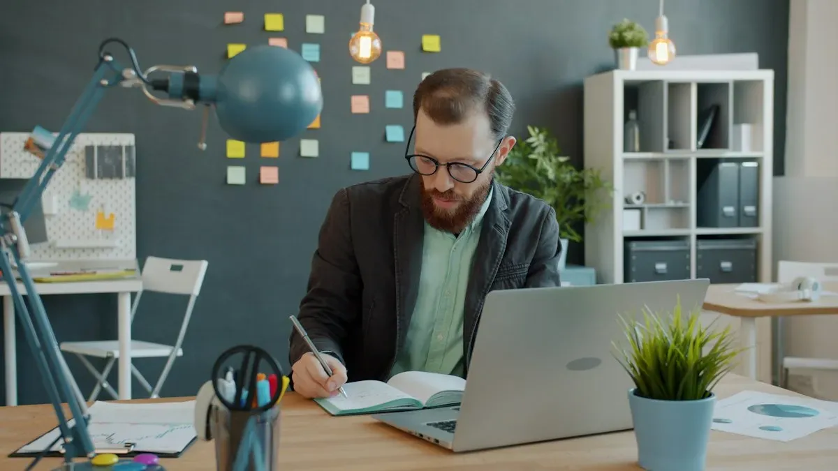 Person working with a laptop and notebook
