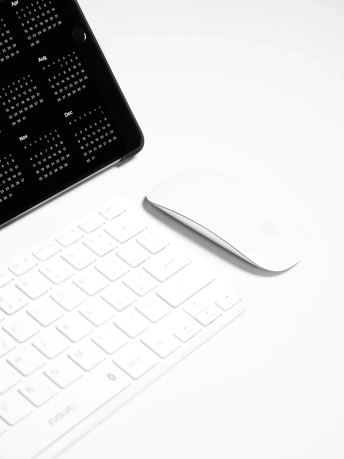 Keyboard and tablet in a white workspace